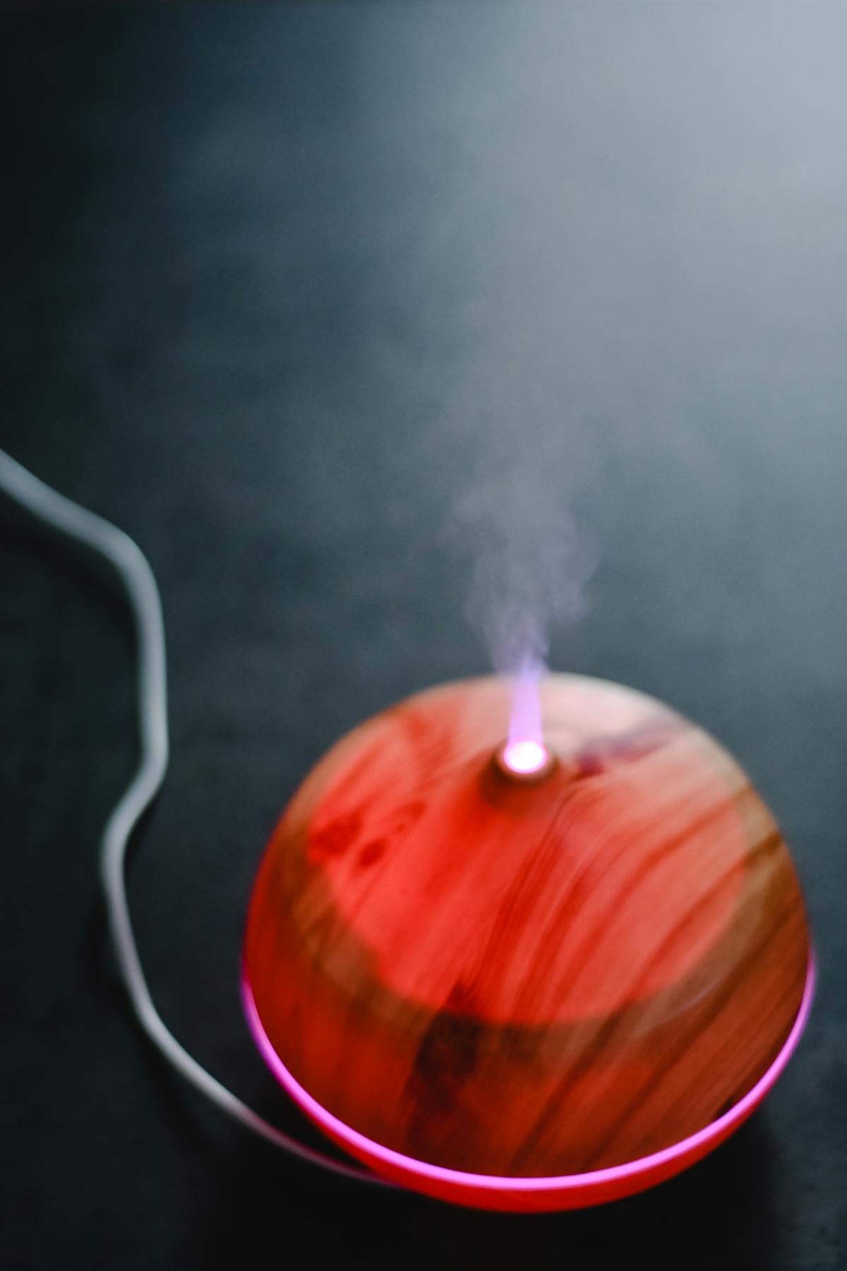 Wood-grain essential oil diffuser producing aromatic mist with LED light - nebulizer vs ultrasonic comparison